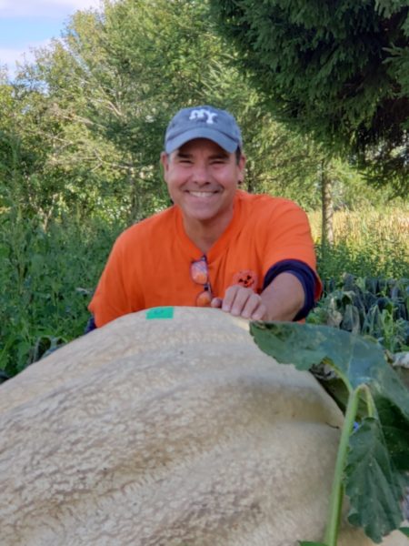 Stellmar Farm - man posing in front of pumpkin