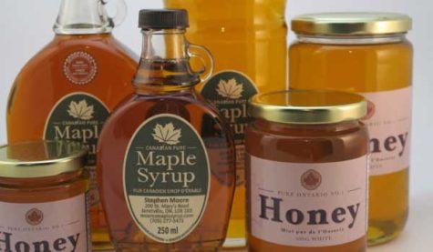 Collection of maple syrup bottles and honey jars