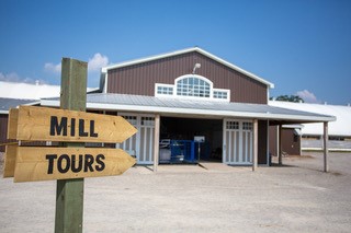 Mill tours sign with woolen mill building