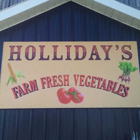 Holliday's Farm Fresh Vegetables sign on barn