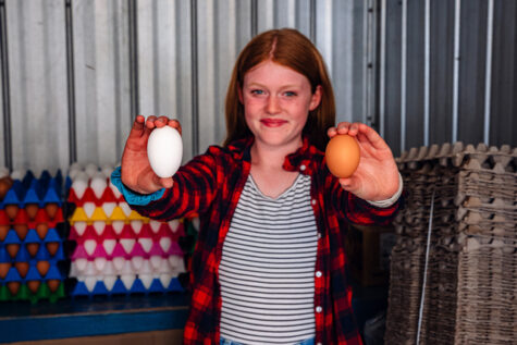 girl with brown and white egg