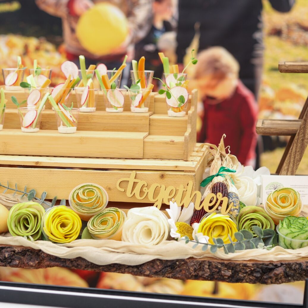 vegetable and dip cups on display with vegetables rolled up to look like decorative flowers